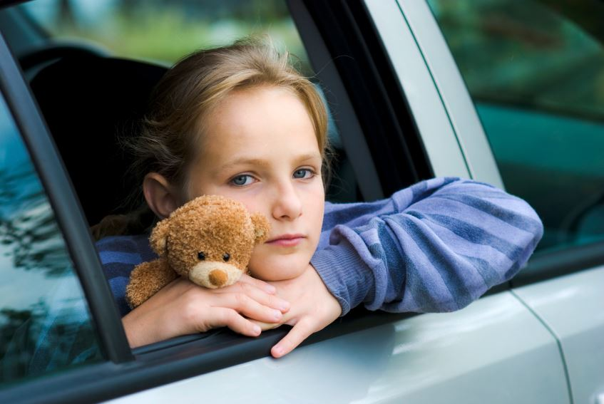 Sad child in car- Navigating Transitions and Change within the Family and with Kids